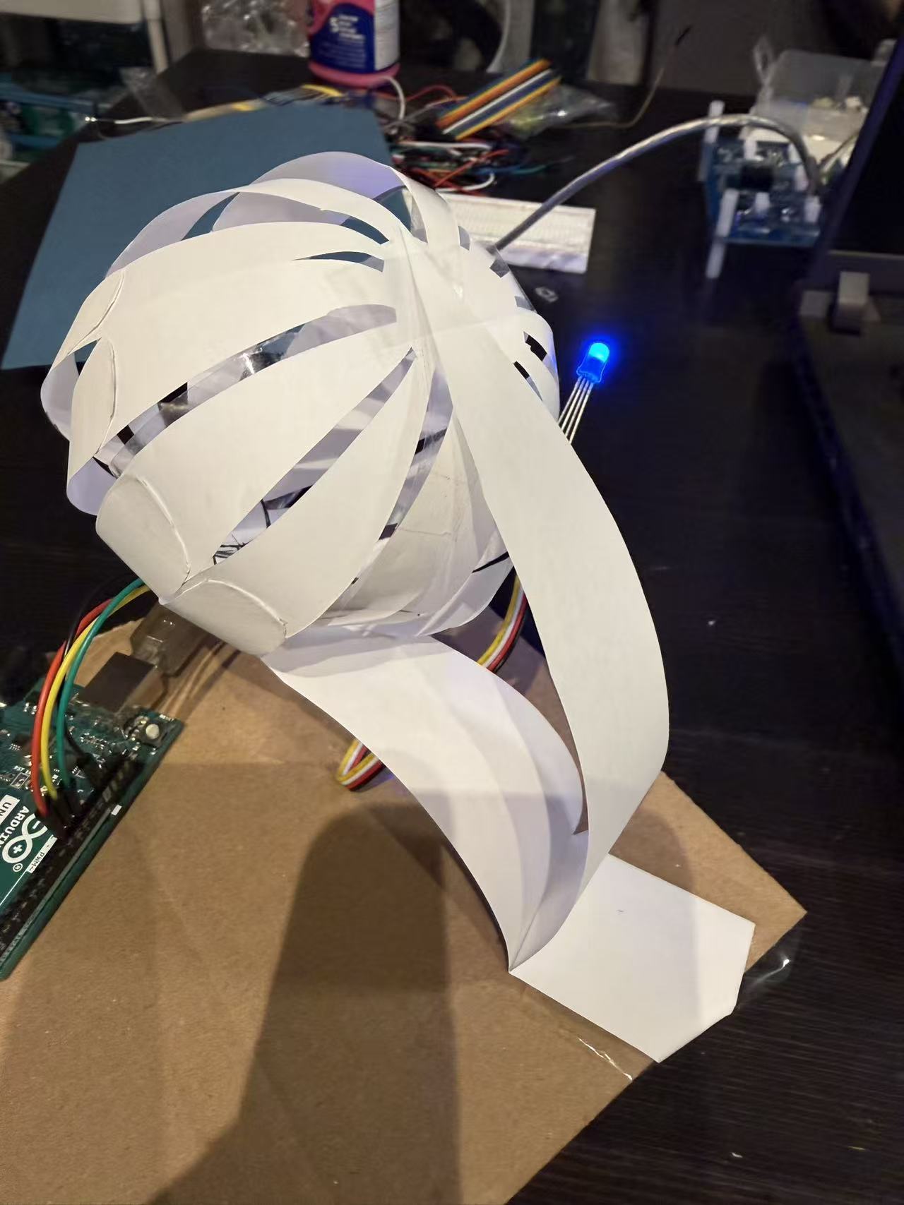 The final prototype combined motion and light, using a paper-strip structure to create a kinetic emotional expression.